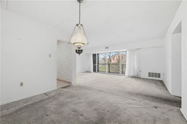 a view of a room with a kitchen