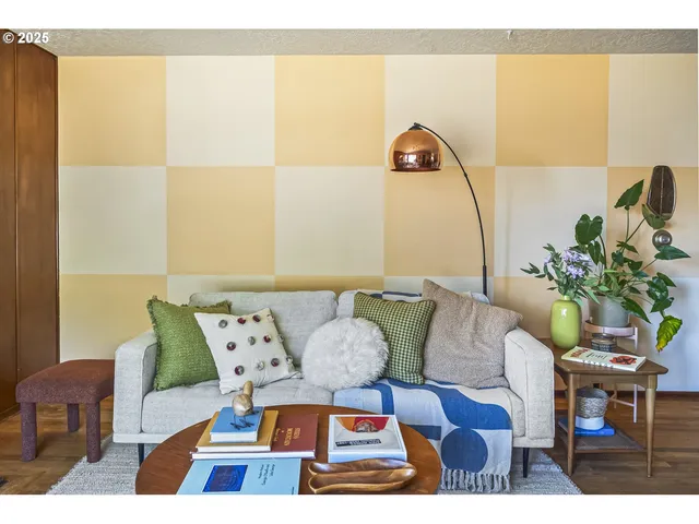 a view of a dining room with furniture and a potted plant