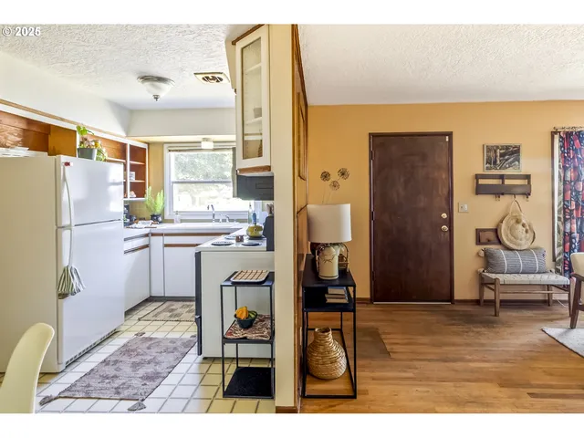 a kitchen with a refrigerator and a stove top oven