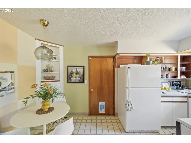 a white refrigerator freezer sitting in a kitchen