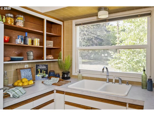 a kitchen with a sink and a large window