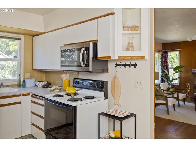 a kitchen with a sink a stove and cabinets