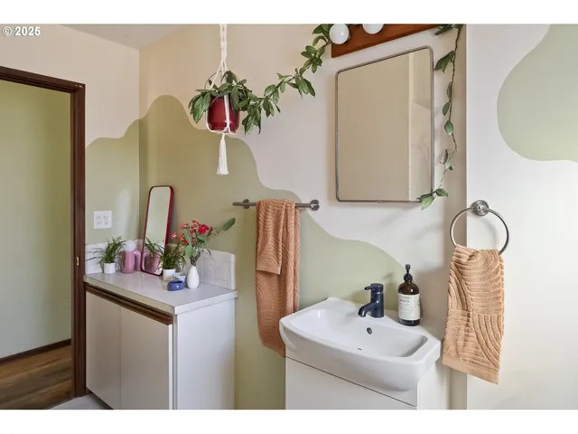 a bathroom with a sink mirror and vanity