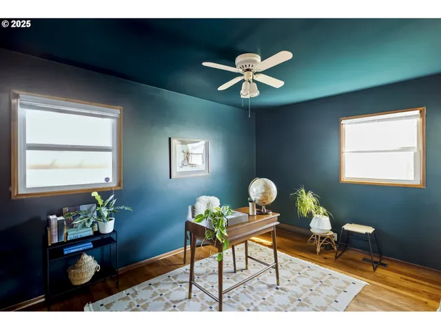 a living room with furniture potted plant and a window