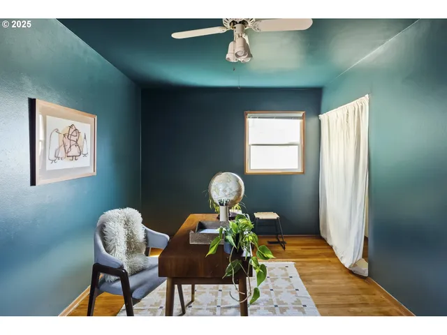 a view of a workspace room with furniture and wooden floor
