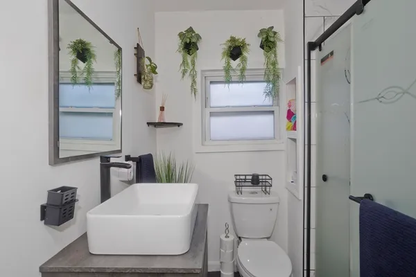 a bathroom with a toilet and a shower