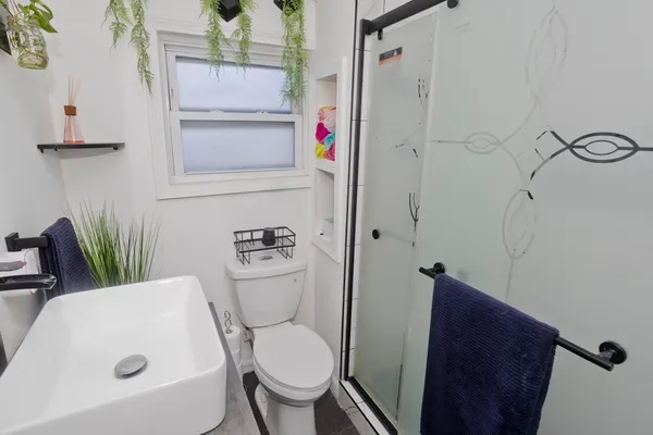 a bathroom with a toilet and a shower