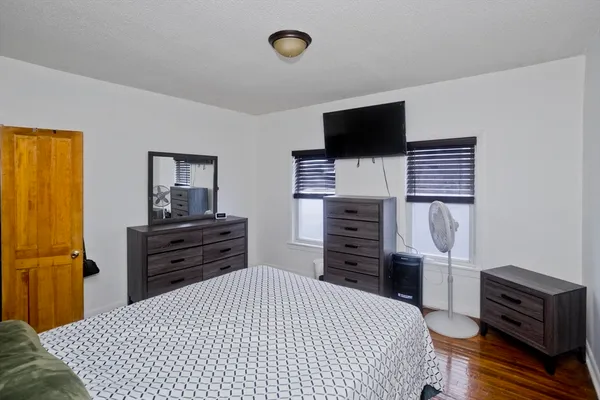 a bedroom with a bed and flat screen tv