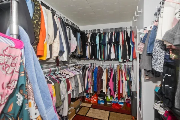 a view of walk in closet with clothes