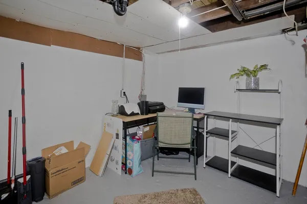 a view of workspace with wooden floor windows