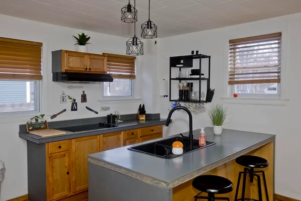 a kitchen with a sink a stove and a microwave