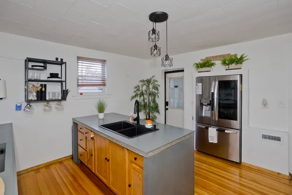 a kitchen with stainless steel appliances granite countertop a sink a stove and refrigerator