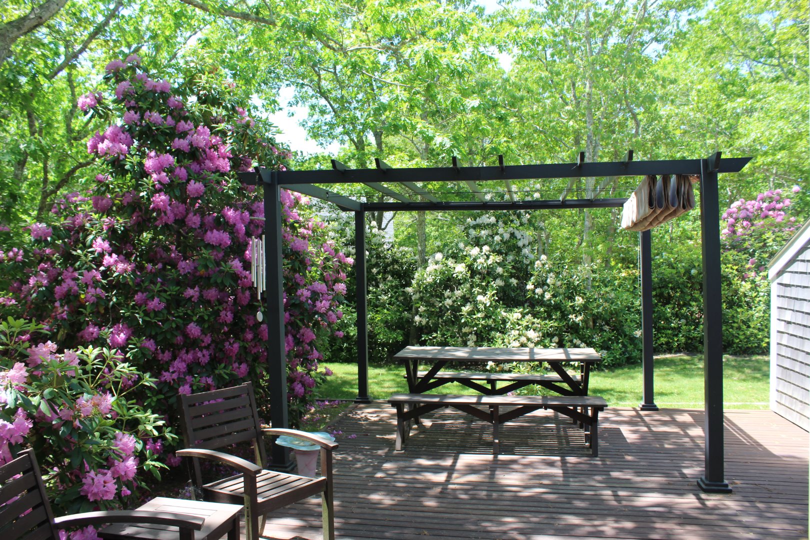 37 Edgartown Meadows Road Edgartown, MA 02539 - Photo 5 of 38 a backyard of a house with wooden floor and outdoor seating