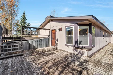 a view of balcony with wooden floor and fence