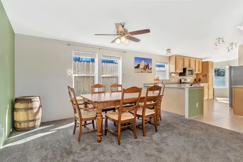 a dining room with furniture and a kitchen view
