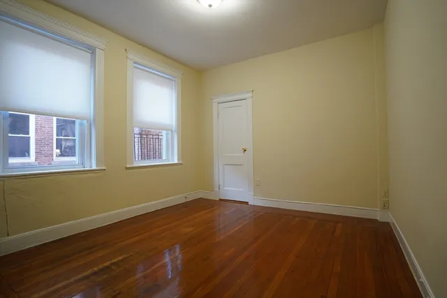 a view of room with wooden floor and fan