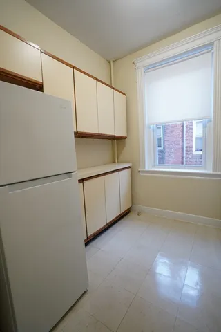 a view of a kitchen with a fridge
