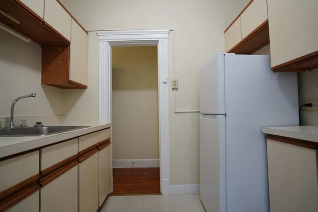 a kitchen with a sink and a refrigerator