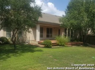 a view of a house with backyard and garden