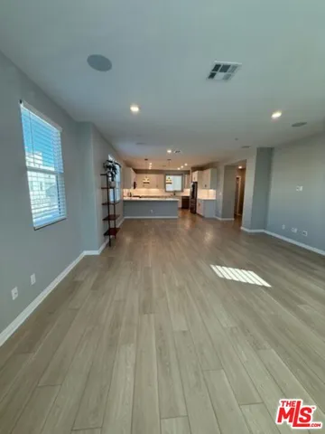 a large kitchen with stainless steel appliances a large counter top a stove and a sink