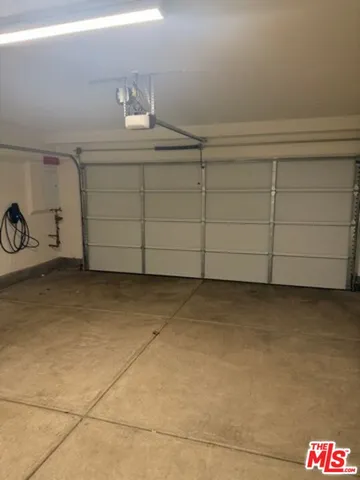 a view of a yard with plants and a tree