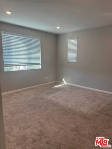 an empty room with closet and a bathroom