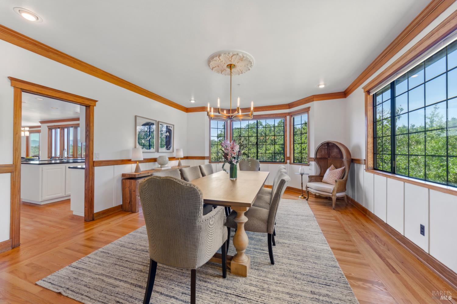 10 Lockton Lane Novato, CA 94945 - Photo 13 of 68 Dining room surrounded by windows, offering natural light and views of the mature trees around the property.