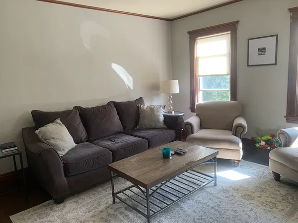 a living room with furniture and a window
