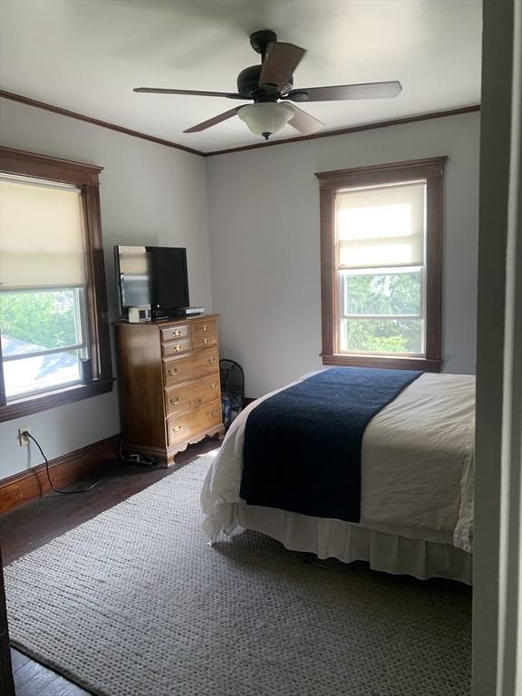 97 Nightingale Avenue, Unit 2 Quincy, MA 02169 - Photo 13 of 17 a bedroom with a bed and a chandelier