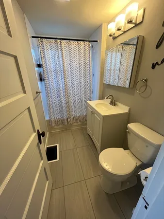 a white toilet sitting next to a bathroom sink and tub