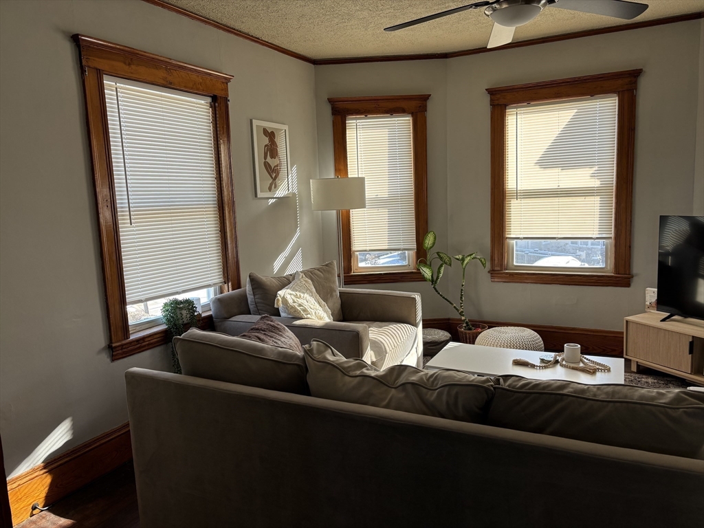 97 Nightingale Avenue, Unit 2 Quincy, MA 02169 - Photo 5 of 17 a living room with furniture and two window