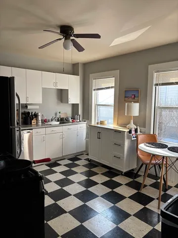 a kitchen with a checkered table and chairs