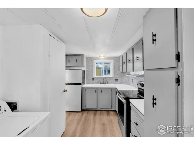 a kitchen with cabinets and window