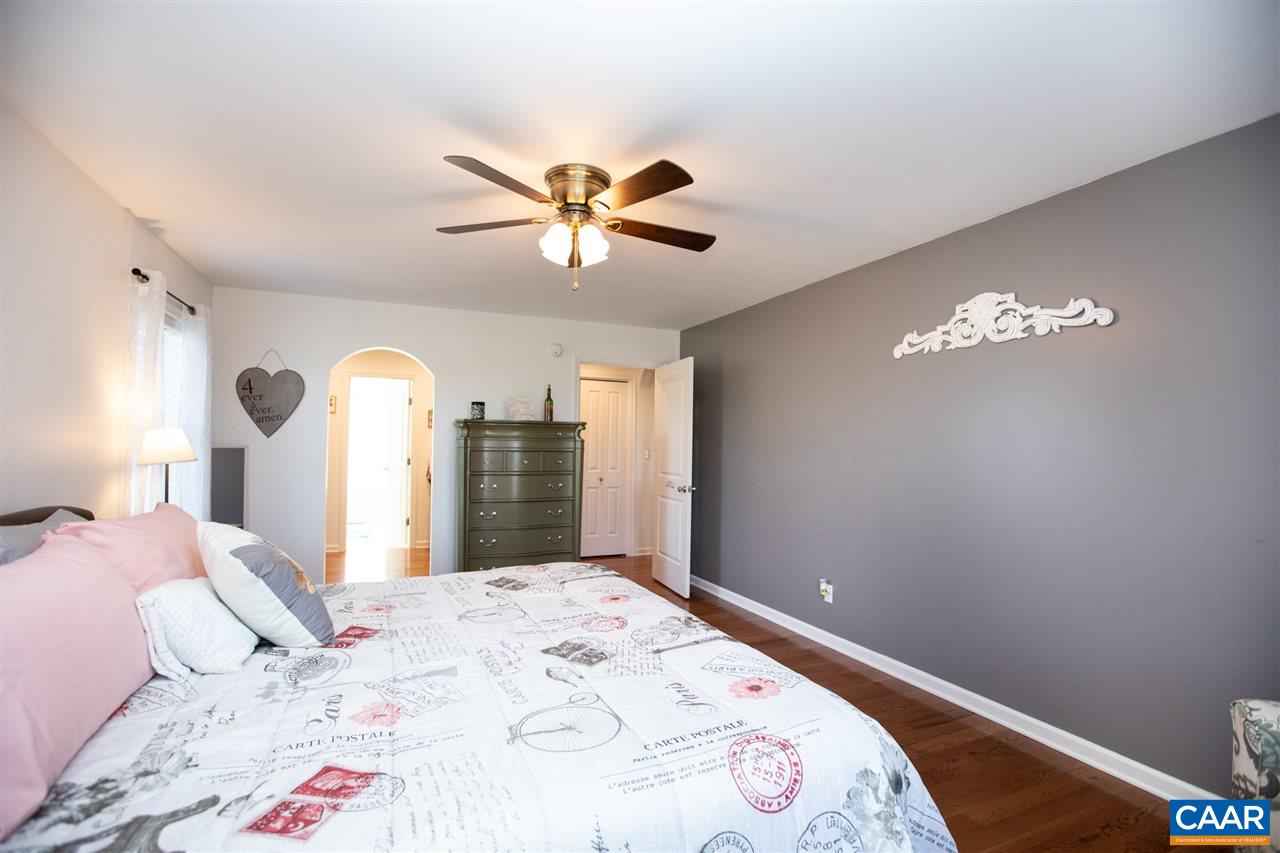 962 School Road Farmville, VA 23901 - Photo 14 of 41 a bedroom with a large bed and a chandelier