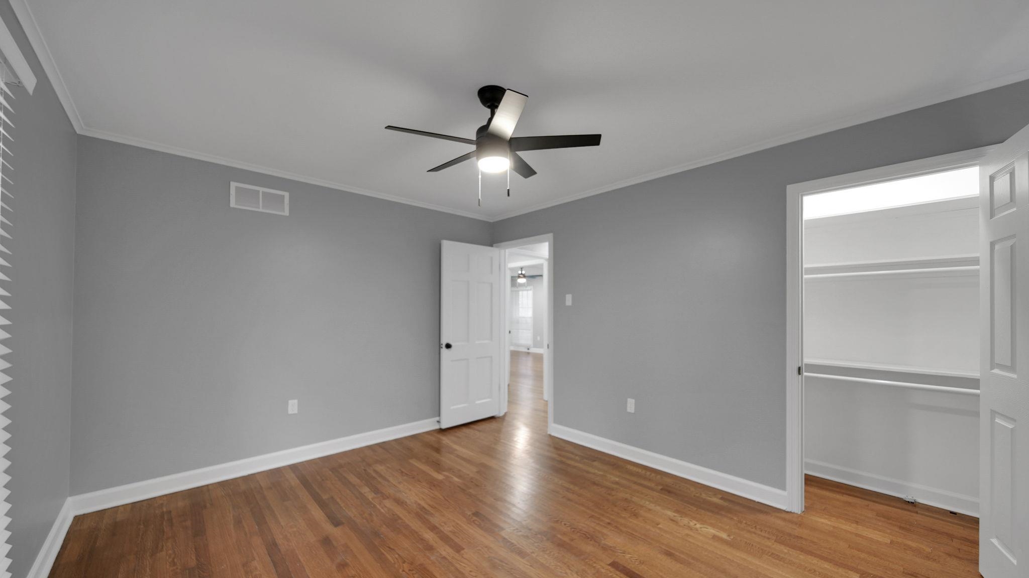 5256 Collingwood Road Memphis, TN 38117 - Photo 27 of 40 Unfurnished bedroom with crown molding, light wood-style flooring, ceiling fan, and a walk in closet