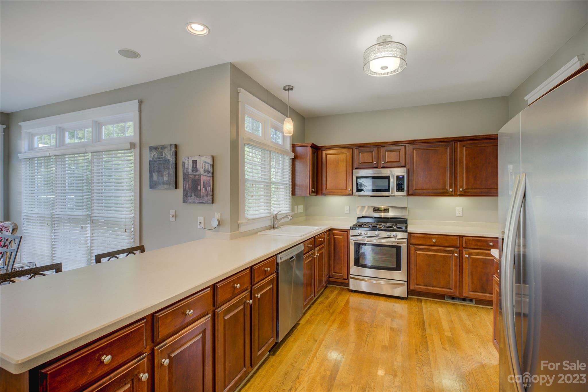 357 Elis Way Fort Mill, SC 29708 - Photo 14 of 48 a large kitchen with stainless steel appliances granite countertop a stove and a sink
