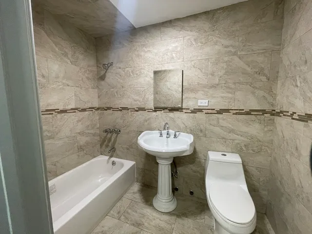 a bathroom with a sink a toilet and bathtub