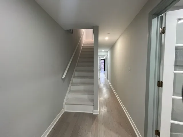 a view of entryway and hall with wooden floor
