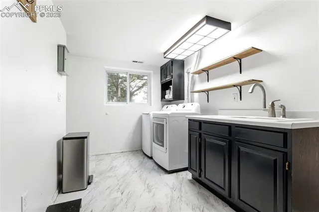 a utility room with sink dryer and washer