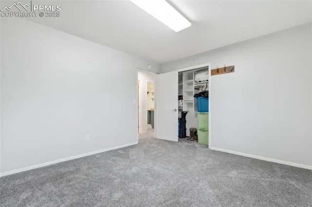 a view of an empty room with closet