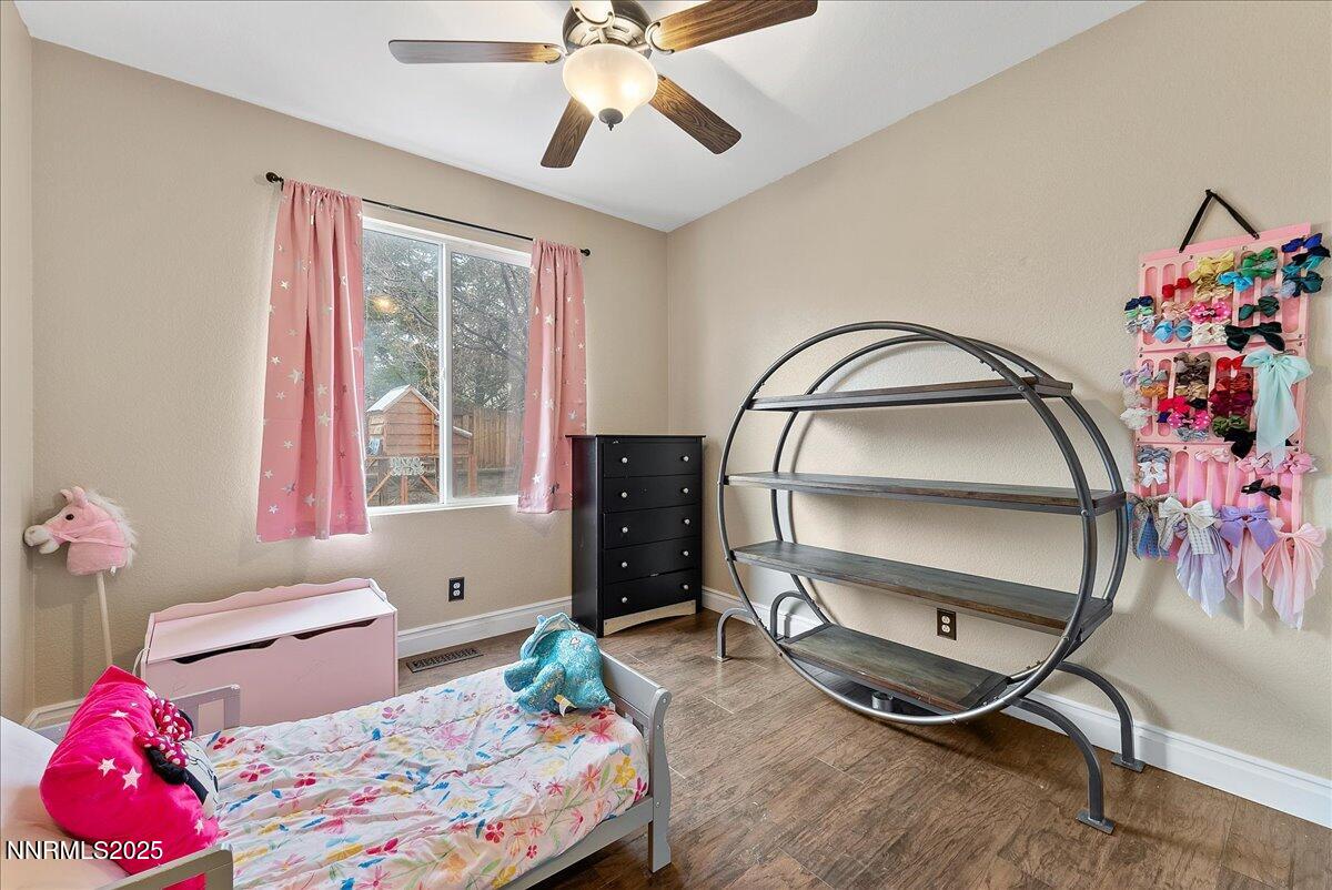 7245 Winterhill Court Reno, NV 89523 - Photo 16 of 25 a bedroom with a bed a chandelier and a window