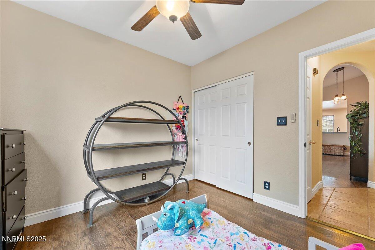 7245 Winterhill Court Reno, NV 89523 - Photo 17 of 25 a room with chandelier fan and wooden floor