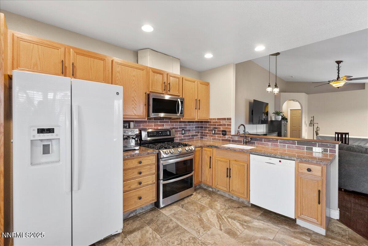 7245 Winterhill Court Reno, NV 89523 - Photo 9 of 25 a kitchen with stainless steel appliances a refrigerator stove microwave and sink
