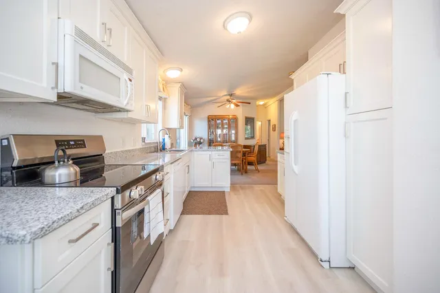 a view of a kitchen with dining table and chairs