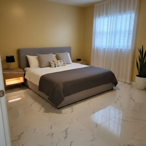 a bedroom with a bed and curtain