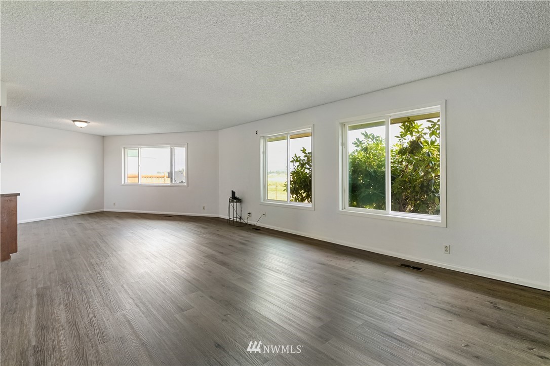 368 West Smith Road Bellingham, WA 98226 - Photo 4 of 24 an empty room with wooden floor and windows