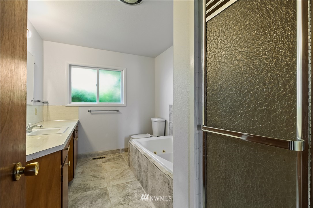 368 West Smith Road Bellingham, WA 98226 - Photo 5 of 24 a bathroom with a granite countertop sink toilet and shower