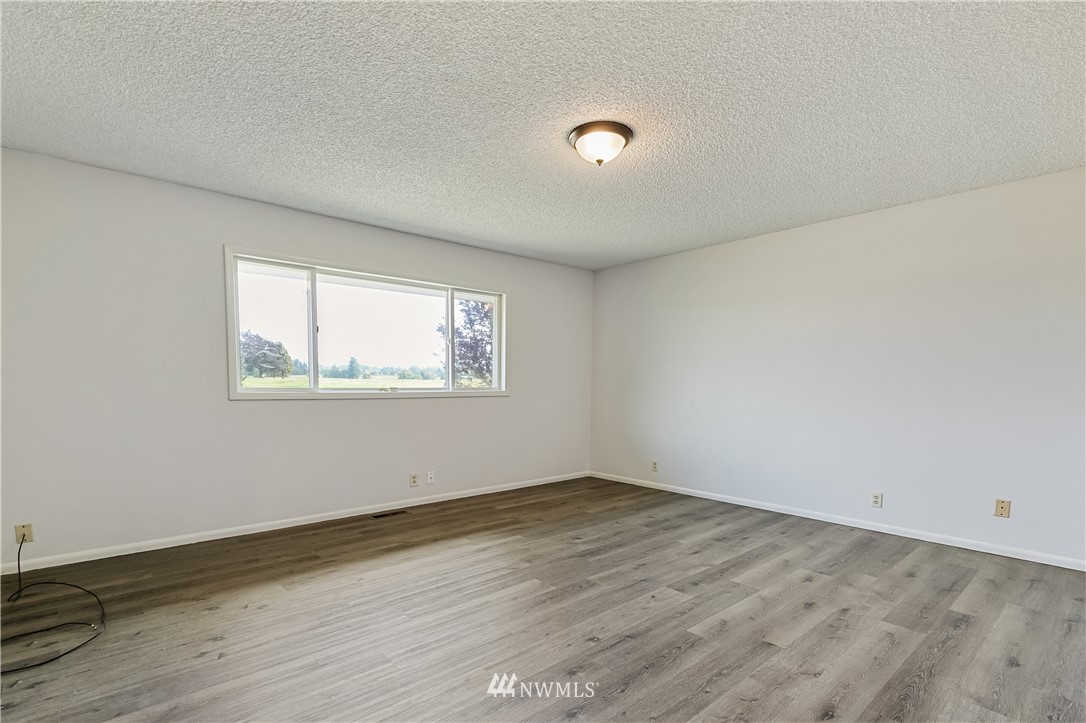 368 West Smith Road Bellingham, WA 98226 - Photo 9 of 24 an empty room with wooden floor and windows