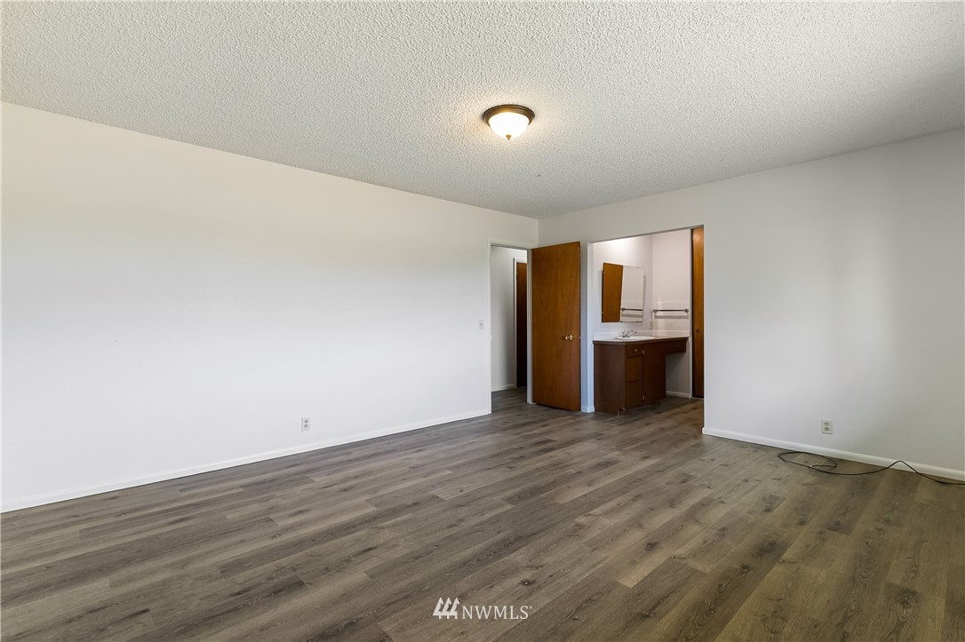 368 West Smith Road Bellingham, WA 98226 - Photo 10 of 24 a view of an empty room with wooden floor and a window