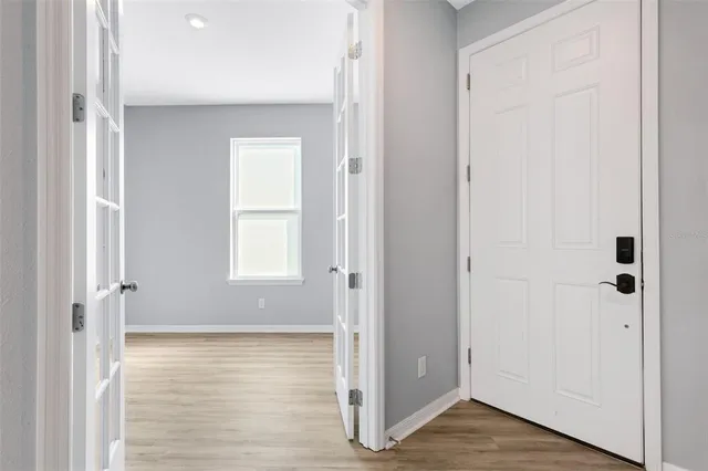 a view of a room with wooden floor